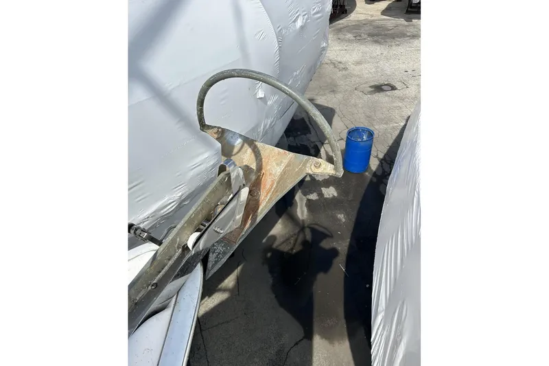 Slide: The Image of Rusty anchor on a 2014 Hunter e33 sailboat, with a blue barrel nearby. - 10