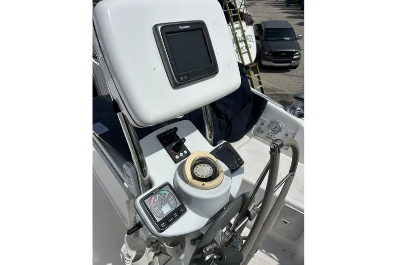 Slide: The Image of Cockpit of 2014 Hunter e33 sailboat with navigation instruments and steering wheel. - 15