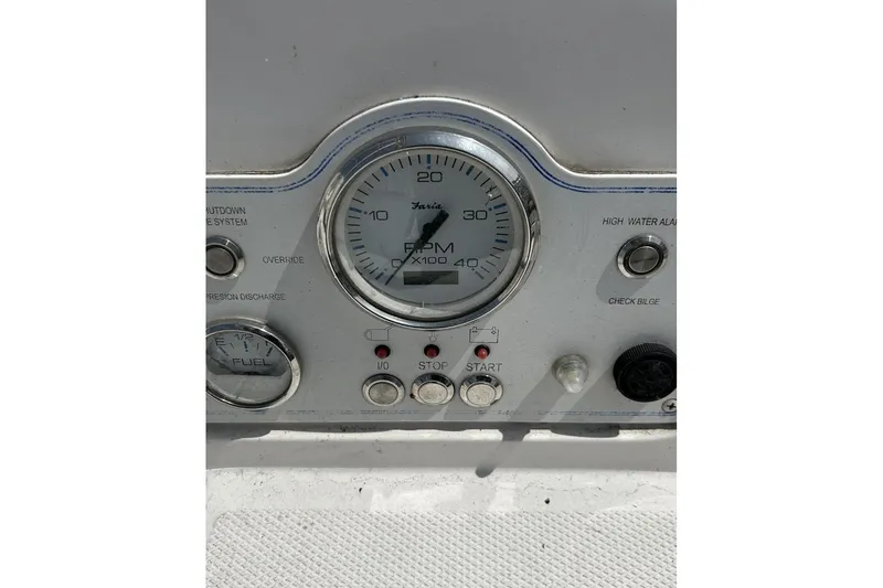 Slide: The Image of Control panel of a 2014 Hunter e33 boat, featuring RPM and fuel gauges. - 16