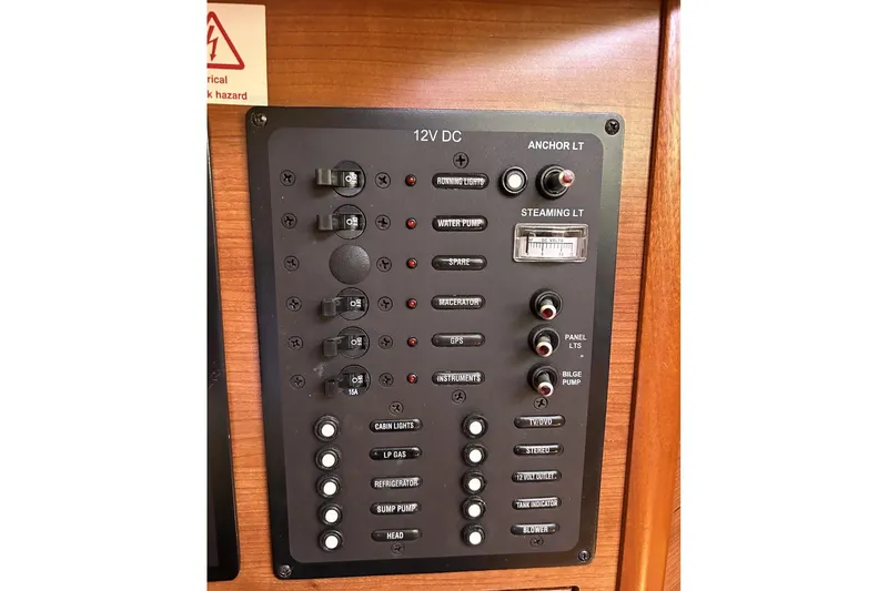 Slide: The Image of Control panel of a 2014 Hunter e33 sailboat with various switches and indicators. - 17