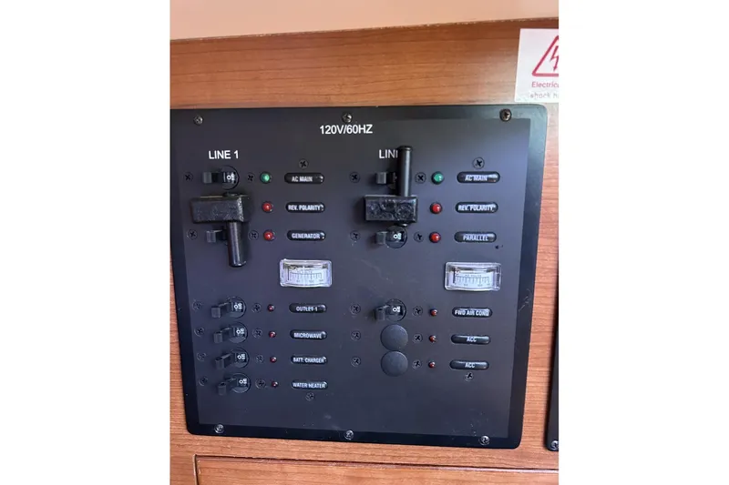 Slide: The Image of Electrical control panel on a 2014 Hunter e33 sailboat, featuring switches and indicators. - 20