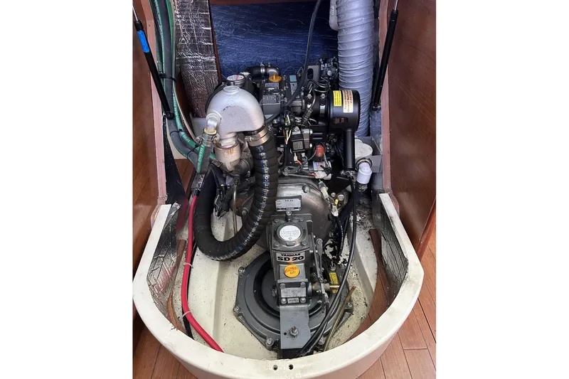 Slide: The Image of Engine compartment of a 2014 Hunter e33 sailboat, showcasing mechanical components and wiring. - 22