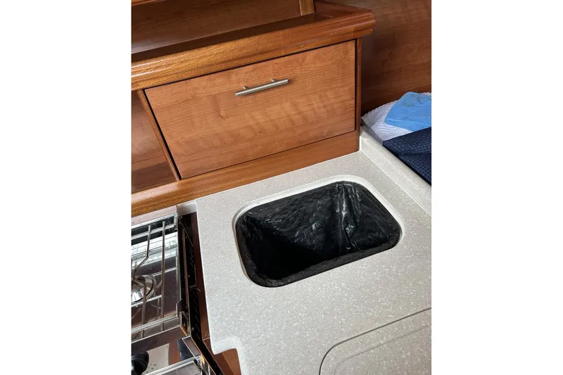 Slide: The Image of Kitchen area of a 2014 Hunter e33 yacht with wooden cabinetry. - 25