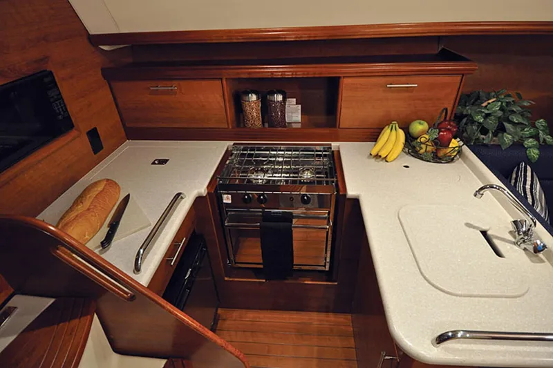 Slide: The Image of Modern galley kitchen in 2014 Marlow-Hunter 33 yacht with stove, sink, and fresh produce. - 26