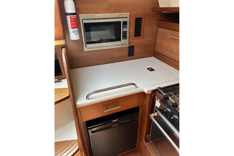 Slide: The Image of 2014 Hunter e33 yacht kitchen with microwave, countertop, and stove. - 27