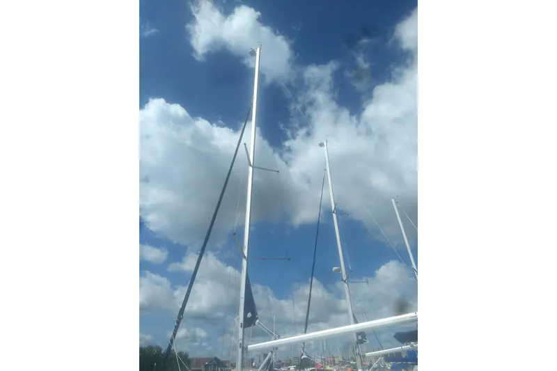 Slide: The Image of Sailboat masts against a cloudy sky, Marlow-Hunter 33, 2014 model. - 3