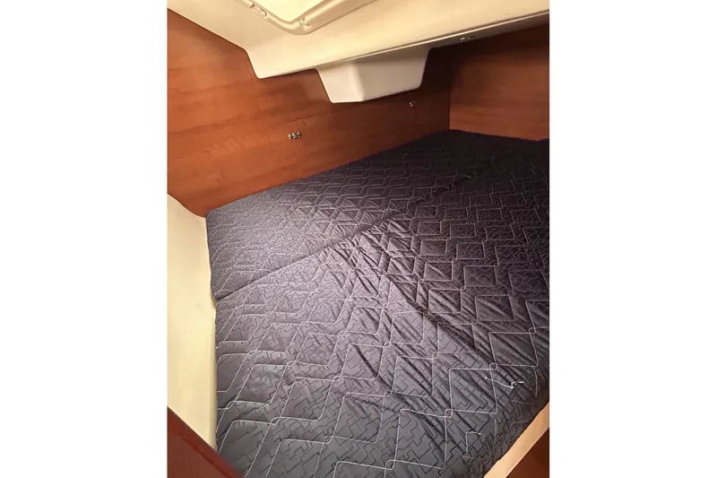 Slide: The Image of Interior cabin of 2014 Hunter e33 sailboat with quilted bedding. - 31