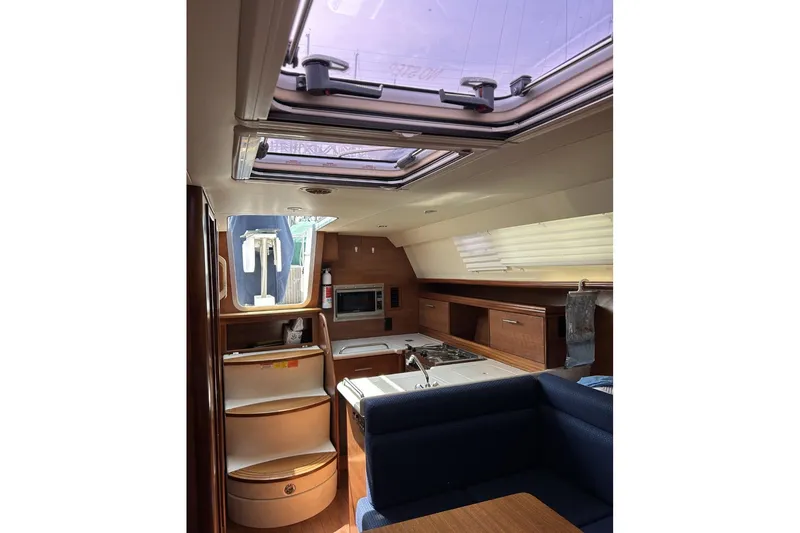 Slide: The Image of Interior of 2014 Hunter e33 sailboat featuring kitchen and seating area. - 32