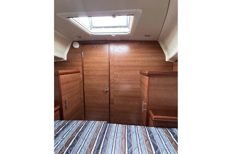 Slide: The Image of Interior cabin of 2014 Hunter e33 sailboat with wood paneling and skylight. - 38