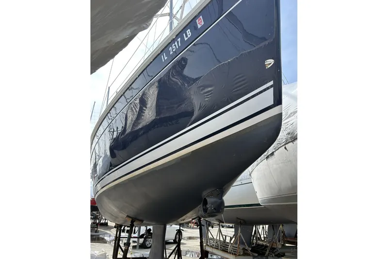 Slide: The Image of 2014 Hunter e33 sailboat on dry dock, showcasing sleek hull design. - 7