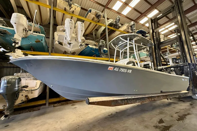 The Image of 2022 Tidewater 2300 Carolina Bay boat in storage, featuring sleek design and powerful engine. - 0