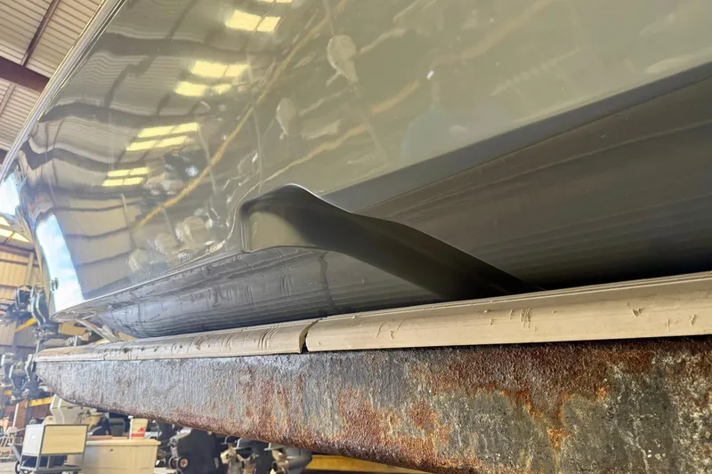 Slide: The Image of 2022 Tidewater 2300 Carolina Bay boat hull in a workshop setting. - 12