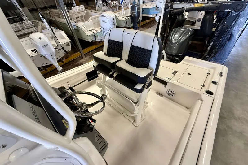Slide: The Image of 2022 Tidewater 2300 Carolina Bay boat interior with dual seats and steering console. - 22