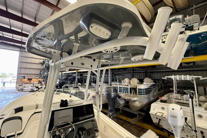 Slide: The Image of 2022 Tidewater 2300 Carolina Bay boat in storage, featuring a Garmin navigation system. - 28