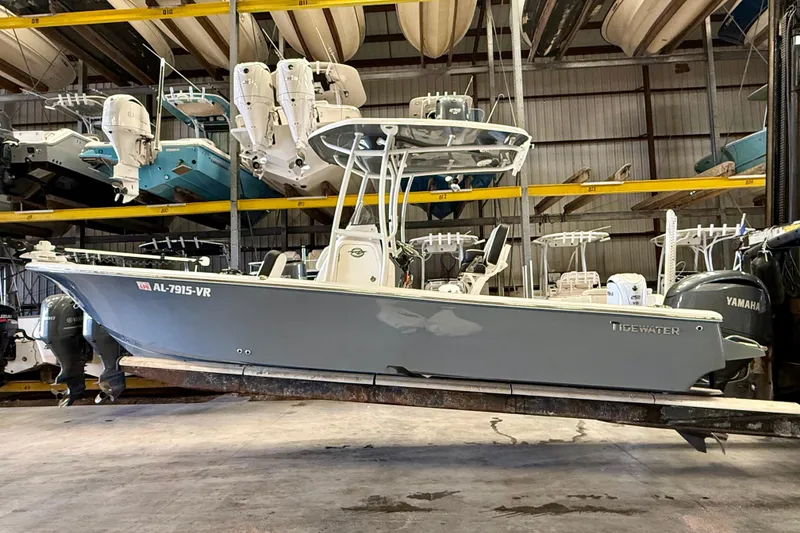 Slide: The Image of 2022 Tidewater 2300 Carolina Bay boat in storage, featuring sleek design and Yamaha engines. - 4