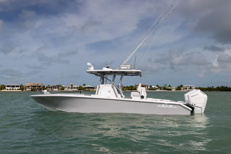 The Image of 2025 SeaHunter 30 Floridian boat on calm waters, with coastal homes in the background. - 0