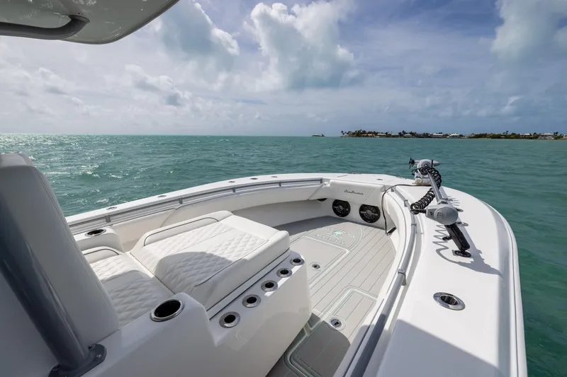 Slide: The Image of 2025 SeaHunter 30 Floridian boat on open water, featuring luxurious seating and modern design. - 11