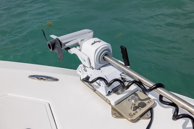 Slide: The Image of Trolling motor on 2025 SeaHunter 30 Floridian boat, mounted on deck near water. - 12