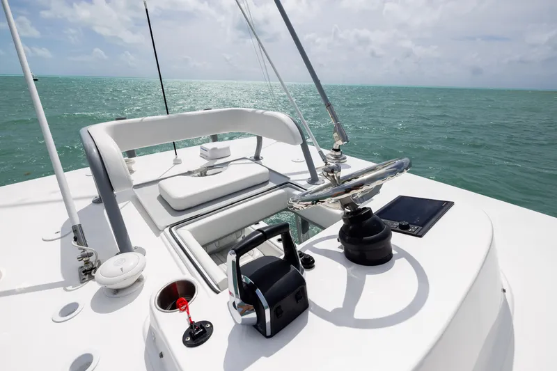 Slide: The Image of 2025 SeaHunter 30 Floridian boat helm with ocean view, featuring modern controls and seating. - 18