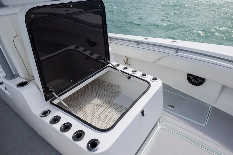 Slide: The Image of Open storage compartment on 2025 SeaHunter 30 Floridian boat, with rod holders and ocean view. - 19