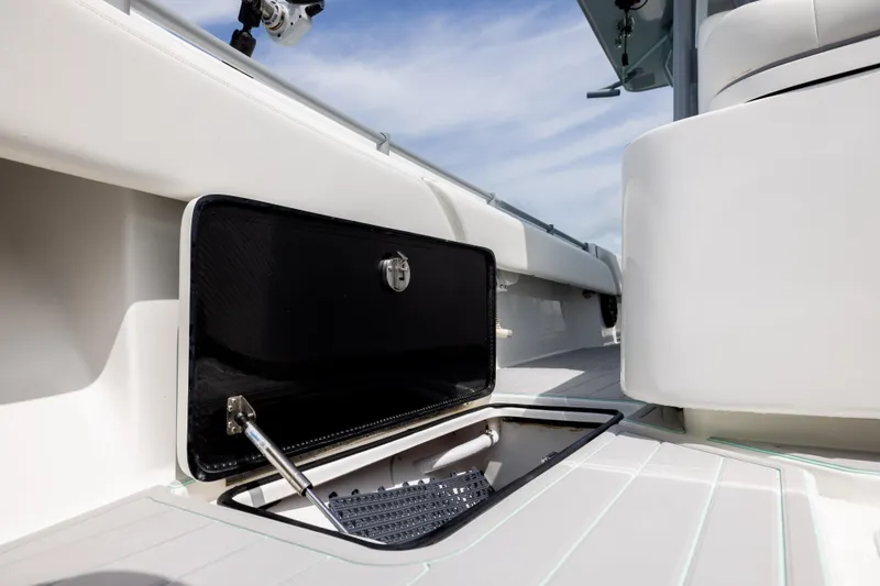 Slide: The Image of 2025 SeaHunter 30 Floridian boat storage compartment with open hatch, showcasing sleek design. - 22