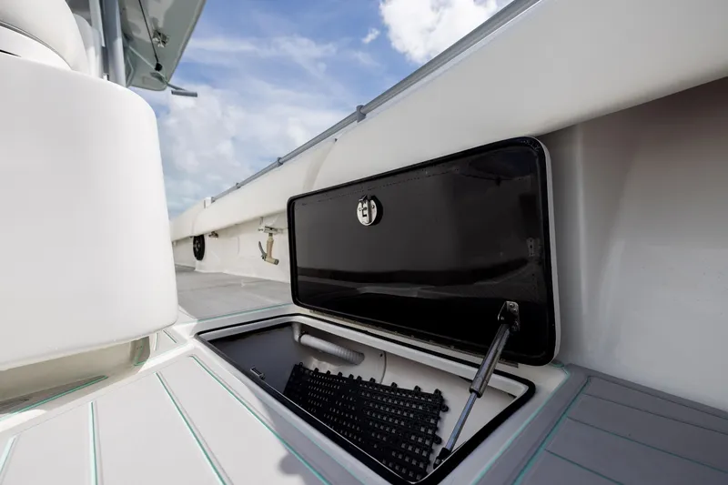 Slide: The Image of Open storage compartment on 2025 SeaHunter 30 Floridian boat under a clear sky. - 23