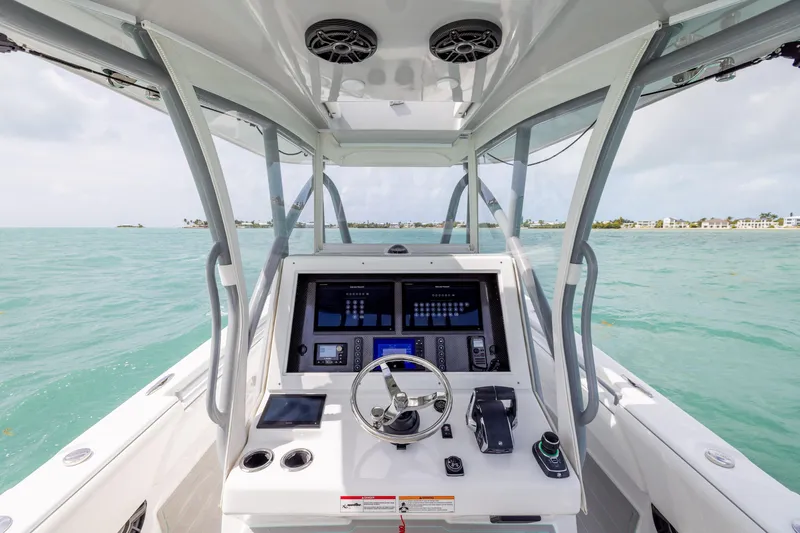 Slide: The Image of Cockpit view of 2025 SeaHunter 30 Floridian boat on turquoise water. - 25