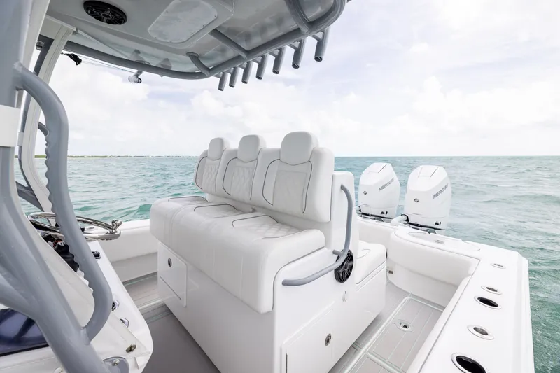 Slide: The Image of 2025 SeaHunter 30 Floridian boat interior with white seating and dual Mercury engines. - 27