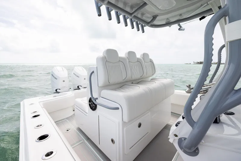 Slide: The Image of 2025 SeaHunter 30 Floridian boat interior with white seating and dual Mercury engines. - 28