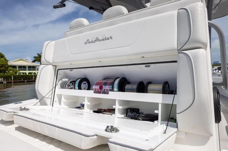 Slide: The Image of 2025 SeaHunter 30 Floridian boat with open storage compartment, showcasing fishing gear and equipment. - 33