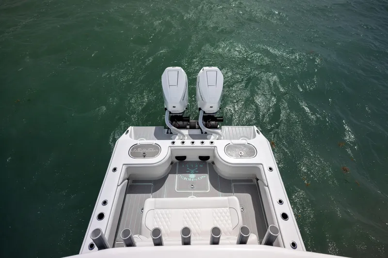 Slide: The Image of 2025 SeaHunter 30 Floridian boat with dual engines on calm water. - 37