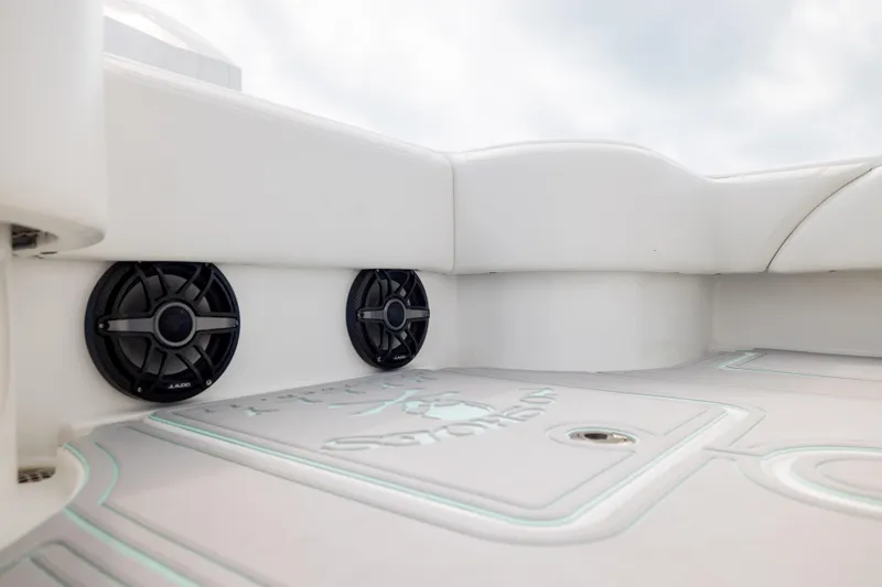 Slide: The Image of 2025 SeaHunter 30 Floridian boat interior with speakers and cushioned seating. - 43