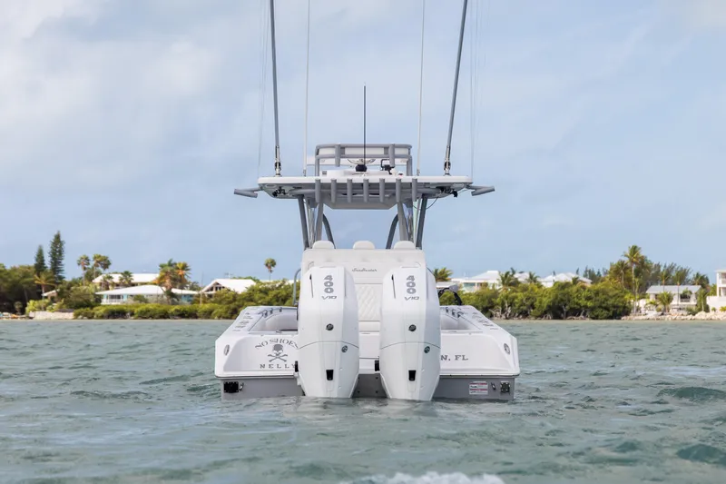 Slide: The Image of 2025 SeaHunter 30 Floridian boat with dual engines on the water, coastal background. - 5