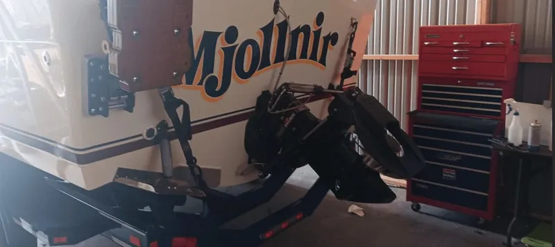 Slide: The Image of Rear view of a 1987 Tiara Yachts Pursuit in a workshop. - 8