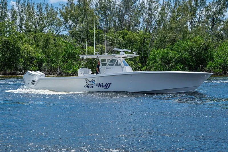 Slide: The Image of 2015 Invincible 42 Open Fisherman boat cruising on a scenic waterway. - 1