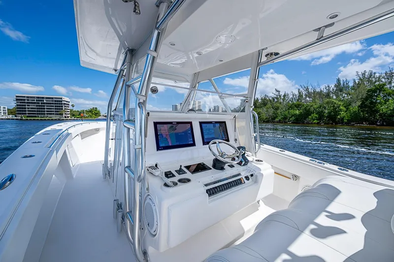 Slide: The Image of 2015 Invincible 42 Open Fisherman boat with modern helm, cruising on a sunny day. - 11