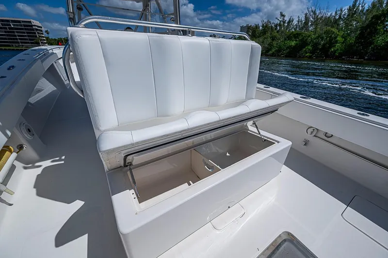 Slide: The Image of 2015 Invincible 42 Open Fisherman boat with open storage compartment and white seating. - 16
