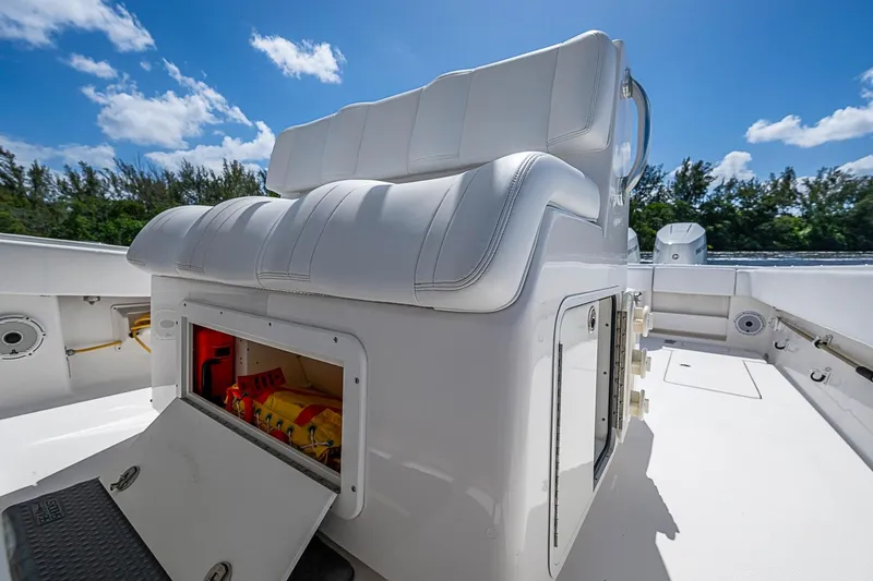 Slide: The Image of 2015 Invincible 42 Open Fisherman boat with white seating and open storage compartment. - 17