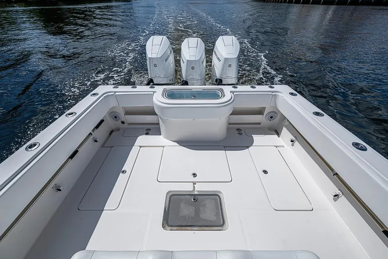 Slide: The Image of 2015 Invincible 42 Open Fisherman boat with triple outboard engines on water. - 18