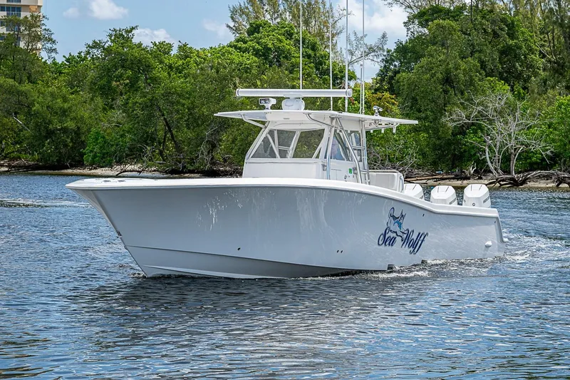 Slide: The Image of 2015 Invincible 42 Open Fisherman boat cruising on a scenic waterway. - 21
