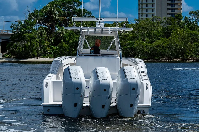 Slide: The Image of 2015 Invincible 42 Open Fisherman boat with four powerful engines on the water. - 24