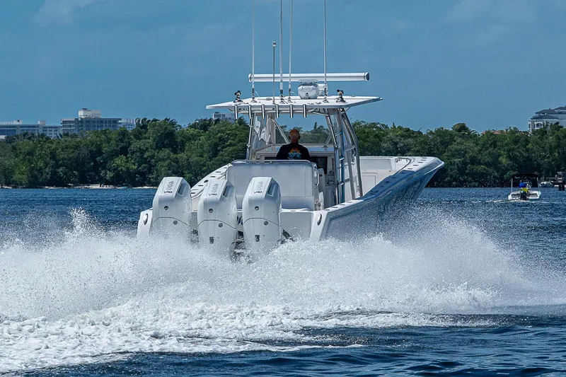 Slide: The Image of 2015 Invincible 42 Open Fisherman speeding on water with triple engines. - 3