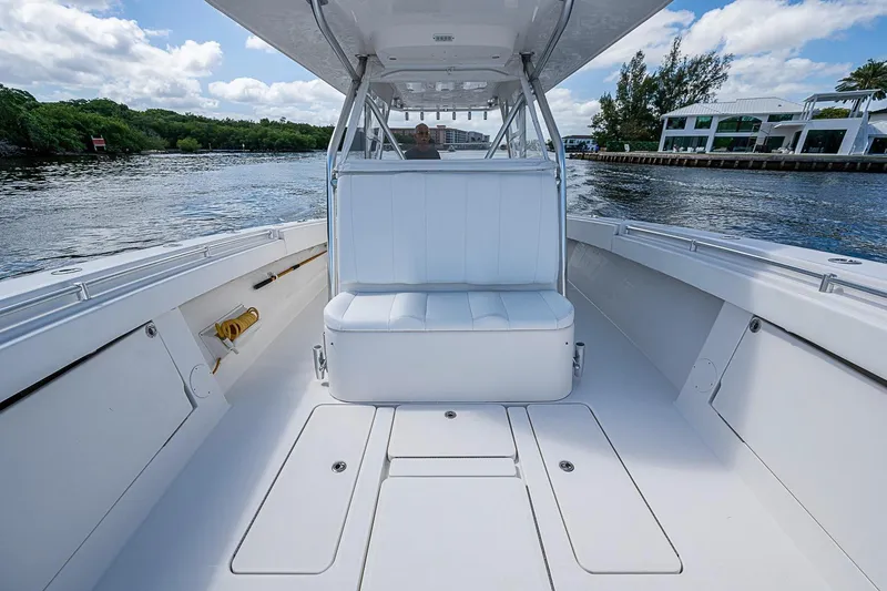 Slide: The Image of 2015 Invincible 42 Open Fisherman boat interior with seating, on calm water. - 9