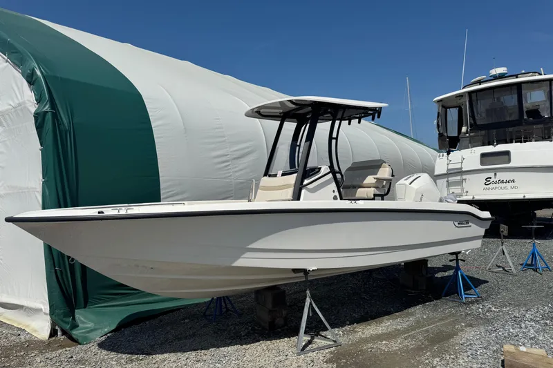 The Image of 2026 Boston Whaler 220 Dauntless boat on stands, outdoor storage area. - 0