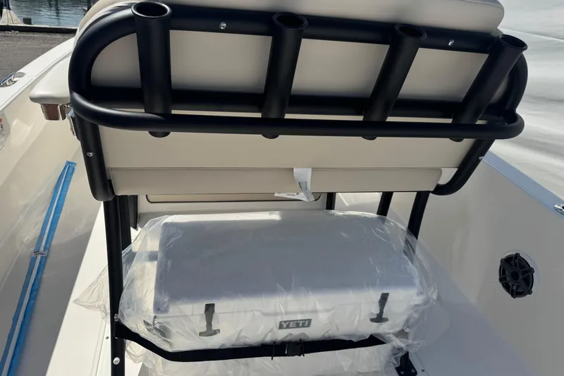 Slide: The Image of Boston Whaler 220 Dauntless 2026 boat interior with rod holders and Yeti cooler. - 10