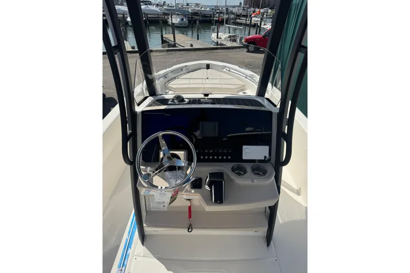 Slide: The Image of 2026 Boston Whaler 220 Dauntless boat console with steering wheel and controls. - 11