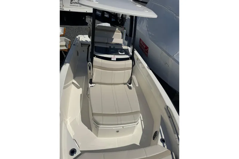 Slide: The Image of 2026 Boston Whaler 220 Dauntless boat interior with seating and console. - 4