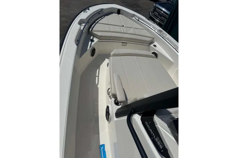 Slide: The Image of 2026 Boston Whaler 220 Dauntless boat interior with cushioned seating and sleek design. - 5