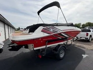 Slide: The Image of 2023 Bayliner VR5 Bowrider I/O on trailer, red and white design. - 16