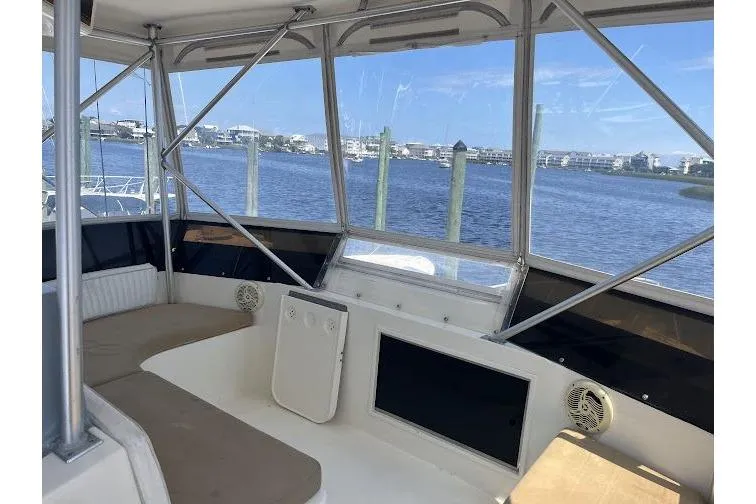 Slide: The Image of Interior view of a 1989 Topaz 44 Sportfisherman boat with scenic waterfront backdrop. - 10